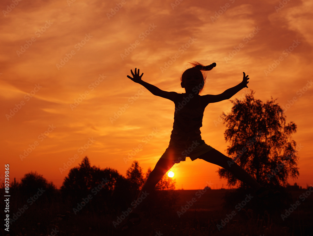 girl jumping at sunset