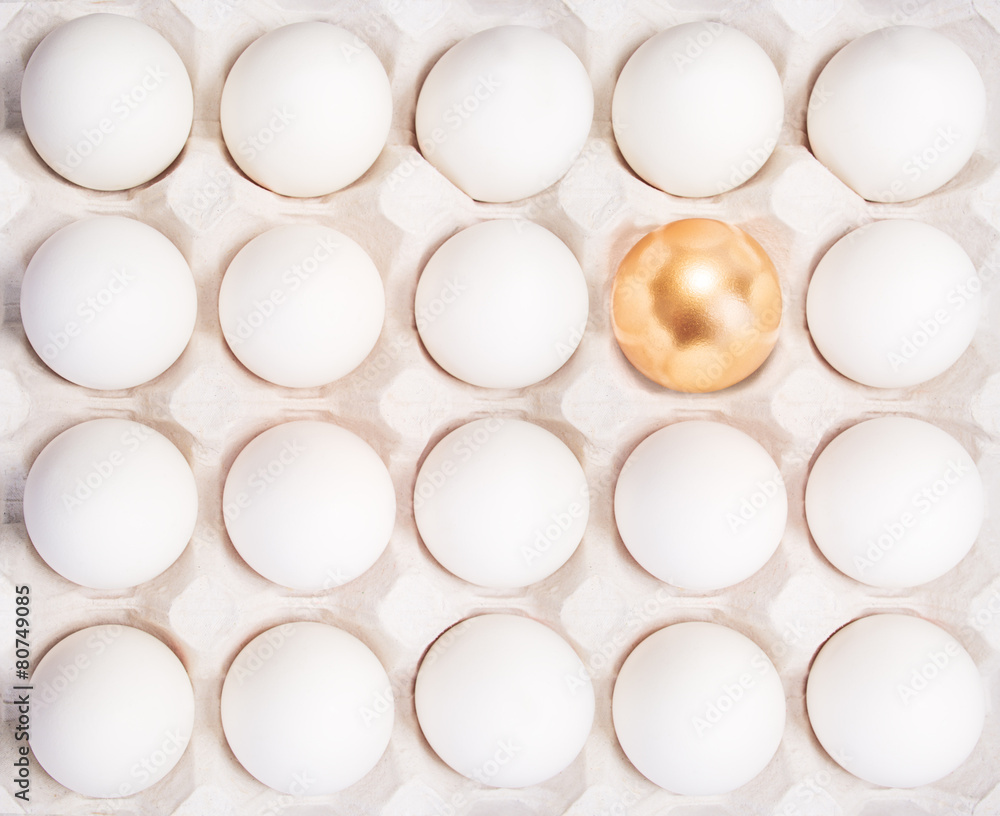 gold Easter egg between many white eggs gold Easter egg between many white eggs
