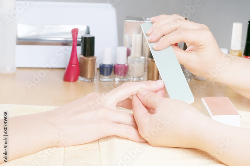 Woman doing a manicure at the beauty salon