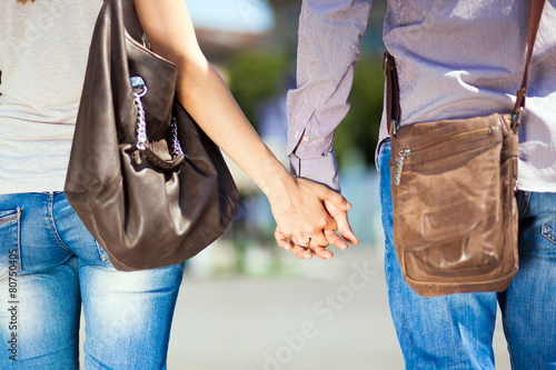 Young couple walking hand by hand