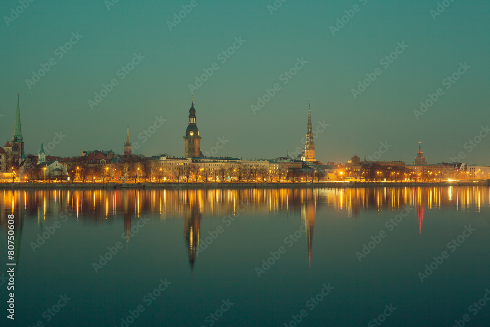 Fototapeta premium Night view of Riga with reflection in river, with retro colors