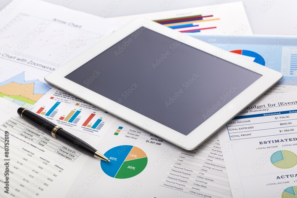 Investment. Financial charts on the table with tablet phone and Investment. Financial charts on the table with tablet phone and
