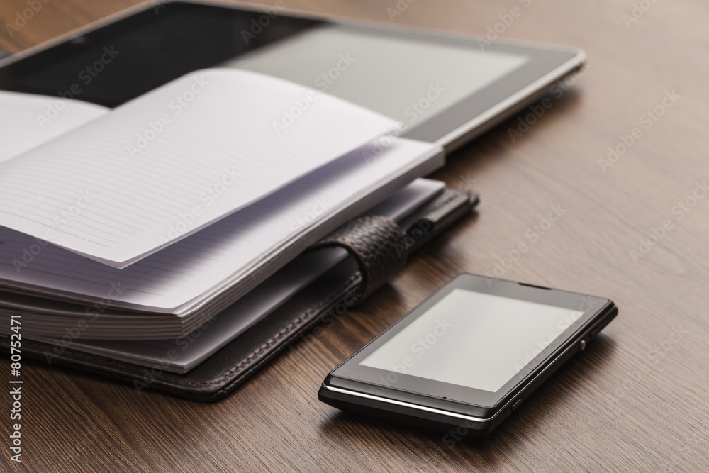 Appointment. Pen, notebook, mobile phone, tablet and discs in a Appointment. Pen, notebook, mobile phone, tablet and discs in a