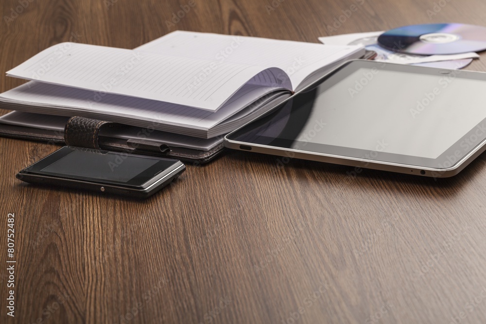 Appointment. Pen, notebook, mobile phone, tablet and discs in a Appointment. Pen, notebook, mobile phone, tablet and discs in a