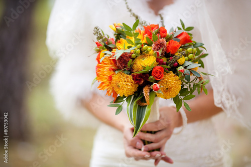 Orange wedding bouquet in hands