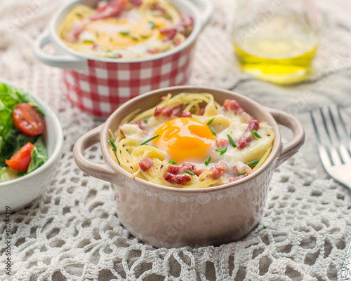 Baked pasta spaghetti carbonara with egg yolk, cheese and bacon