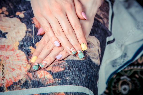 Manicure on the tablecloth of flowers photo