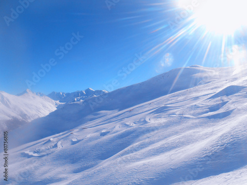 Ski snow slope and blue sky with sun