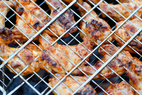 Chicken legs on a barbecue.