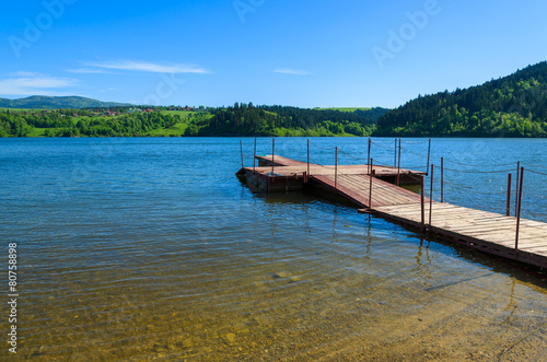 Wooden jetty on Czorsztynskie lake in spring landscape of Poland © pkazmierczak