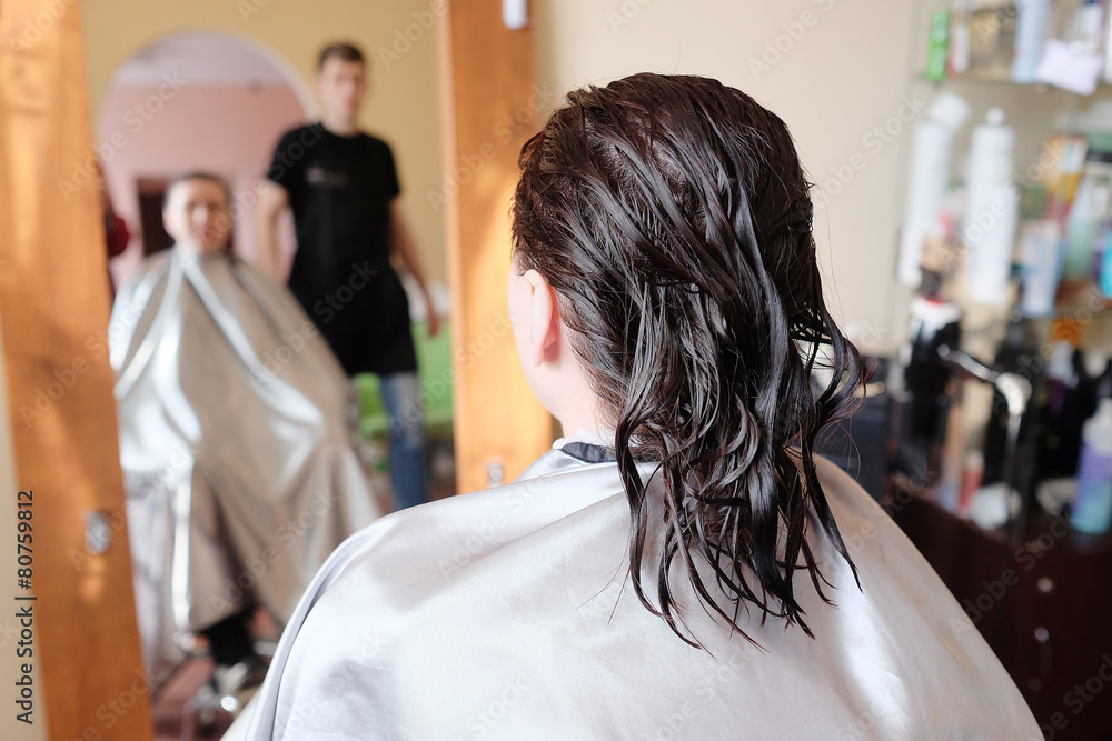 Reflection in mirror woman brunette in hairdressing salon. Reflection in mirror woman brunette in hairdressing salon.