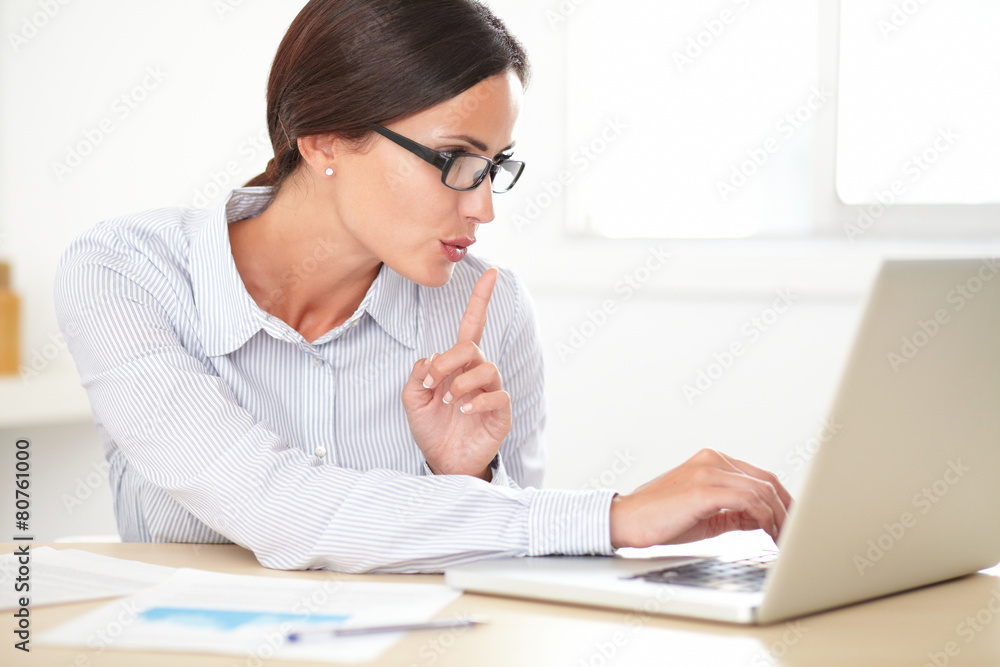 Pretty female executive using her laptop Pretty female executive using her laptop