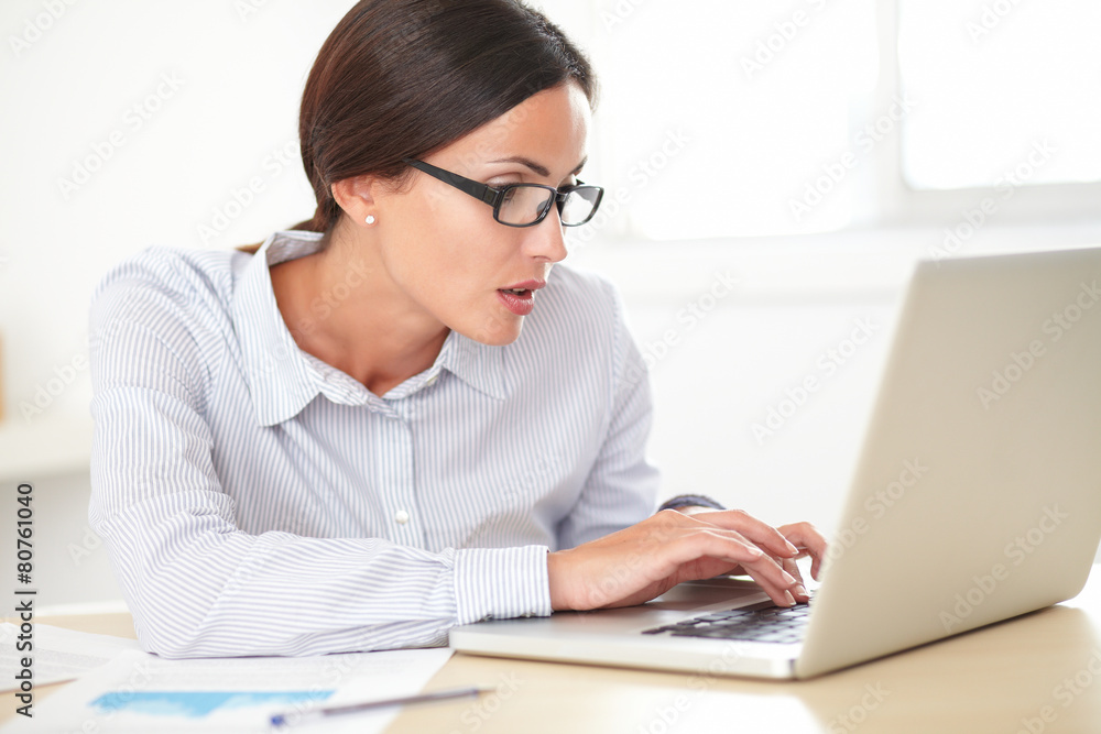 Latin pretty receptionist working on the laptop Latin pretty receptionist working on the laptop
