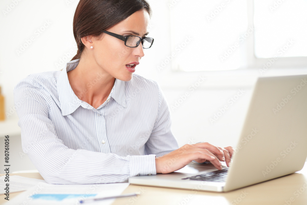 Confident girl secretary using her computer Confident girl secretary using her computer