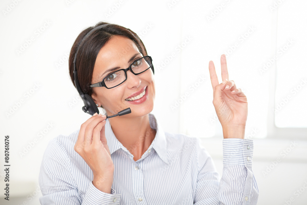 Successful businesswoman speaking on the earphone Successful businesswoman speaking on the earphone