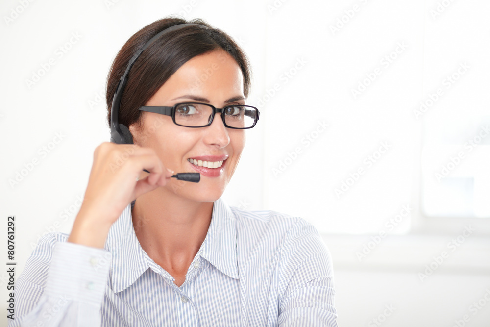 Pretty secretary conversing on the headphones Pretty secretary conversing on the headphones