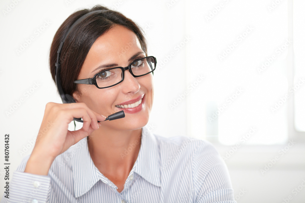 Charming young woman speaking on headphones Charming young woman speaking on headphones