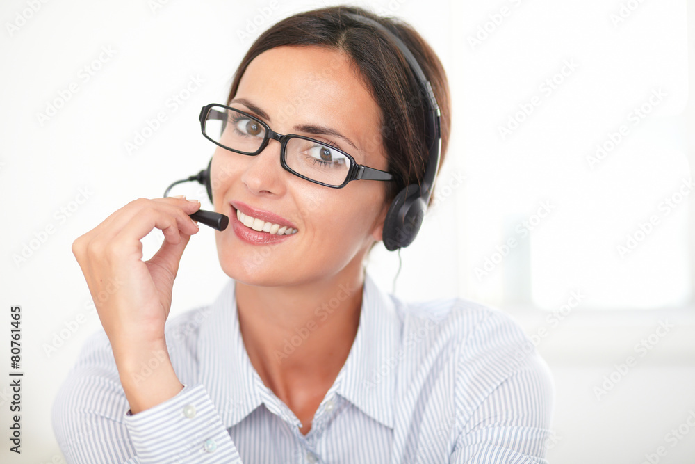 Young business employee talking on headphones Young business employee talking on headphones