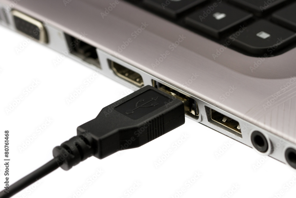 USB cable plugged in to laptop computer USB cable plugged in to laptop computer