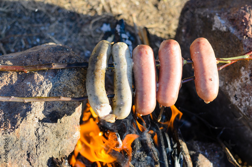 Sausages and Weiners on Stick Cooking over Fire photo