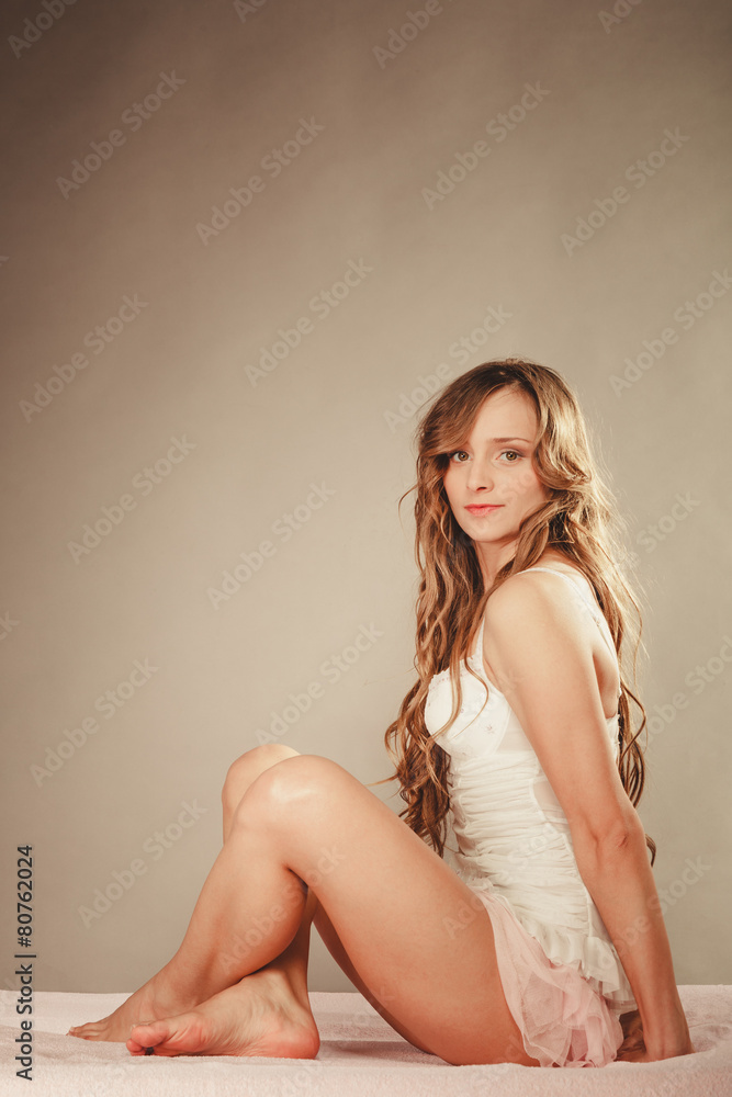 woman long curly hair relaxing on her bed at morning woman long curly hair relaxing on her bed at morning