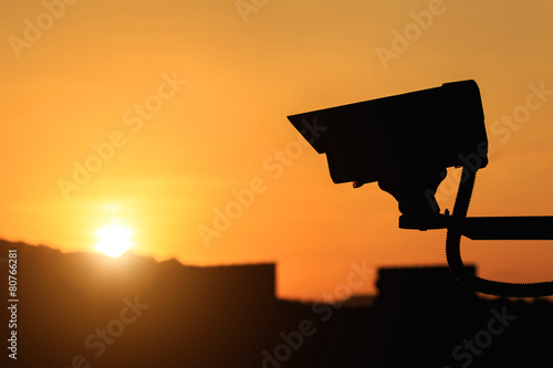 Silhouette of Security CCTV camera with sunset background