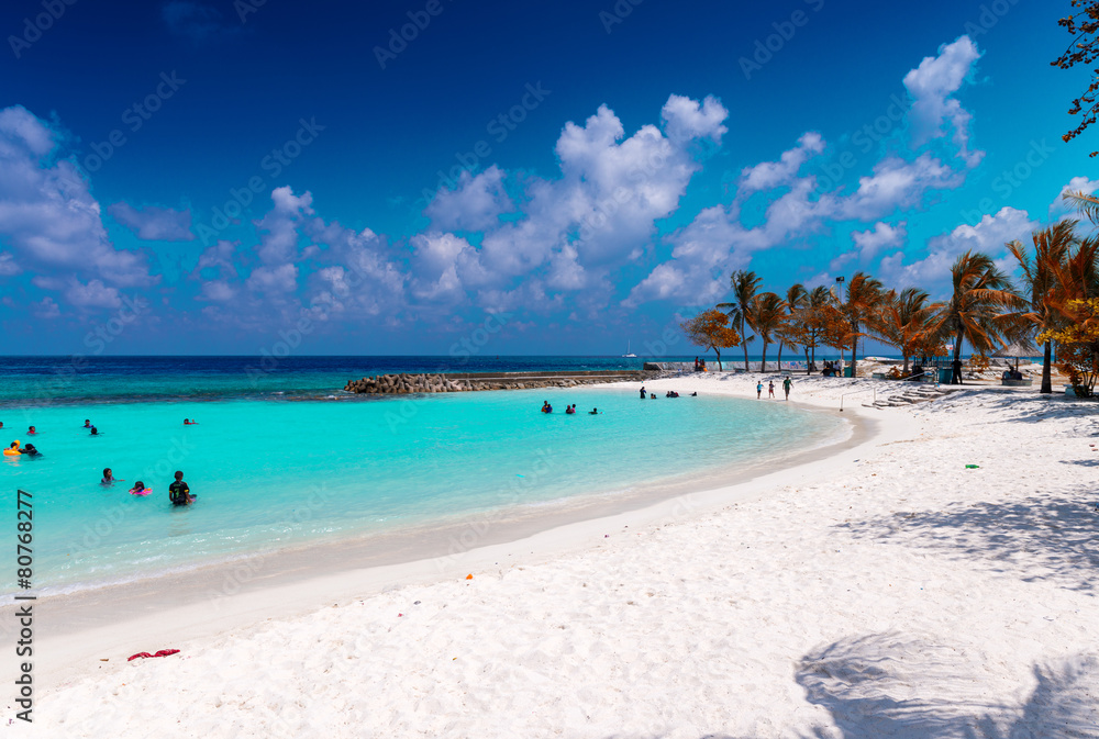 MALE', MALDIVES - MARCH 7, 2015: Locals and tourists relax on ci