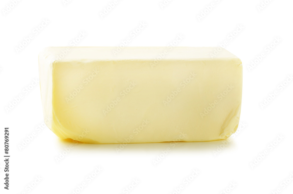 Stick of butter, cut, isolated on white.