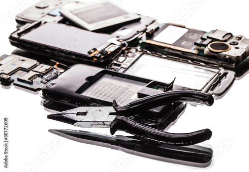 broken phones and pliers closeup