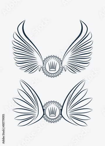 Set of two outlined heraldic designs with wings and crown