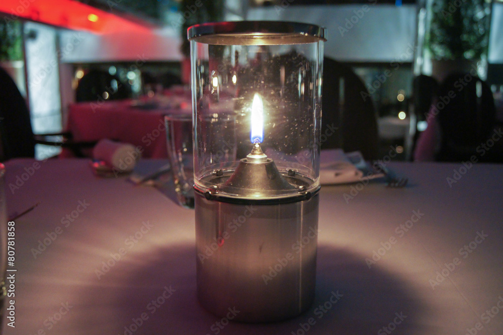 candle in a glass on the table