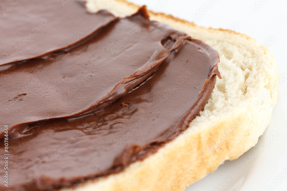 Detail of chocolate nut spread on white sandwich bread. Detail of chocolate nut spread on white sandwich bread.