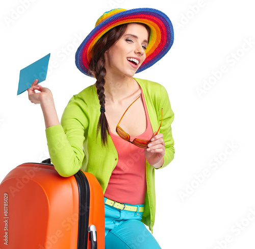 Portrait of female tourist with travel suitcase and blue boardin photo