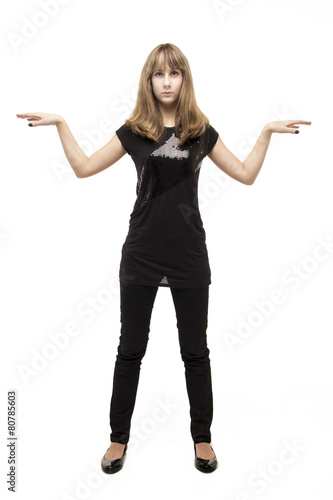 Young cheerful girl standing in the studio isolated
