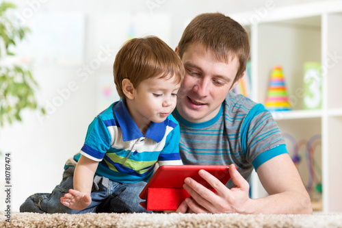 happy father and his child with tablet pc
