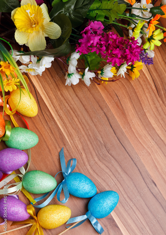 Easter flower arrangement and colorful eggs on wooden surface Easter flower arrangement and colorful eggs on wooden surface