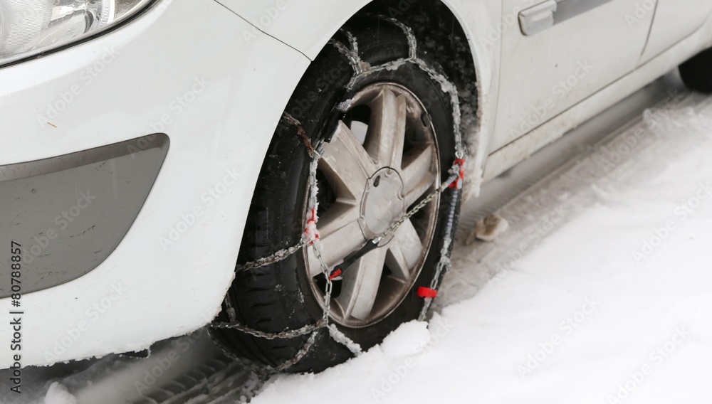 car tire with snow chains in winter cold