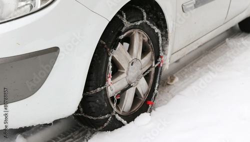 car tire with snow chains in winter cold