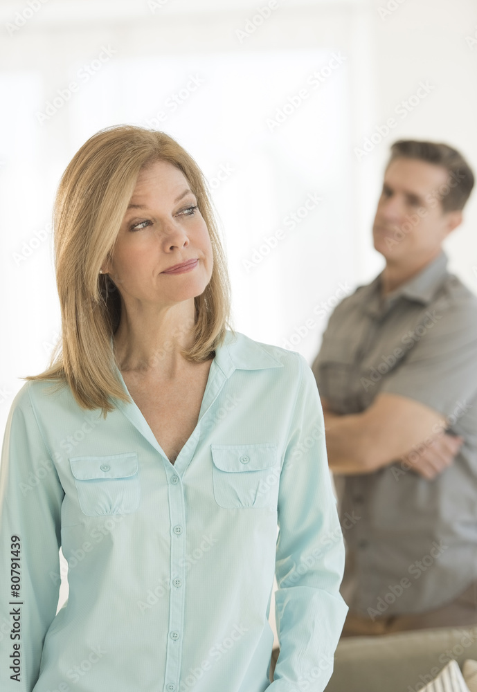 Angry Woman Looking Away With Man In Background At Home Angry Woman Looking Away With Man In Background At Home