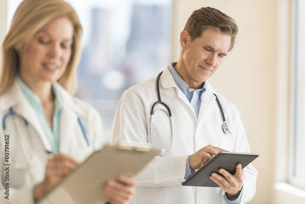 Male Doctor Using Digital Tablet At Hospital Male Doctor Using Digital Tablet At Hospital