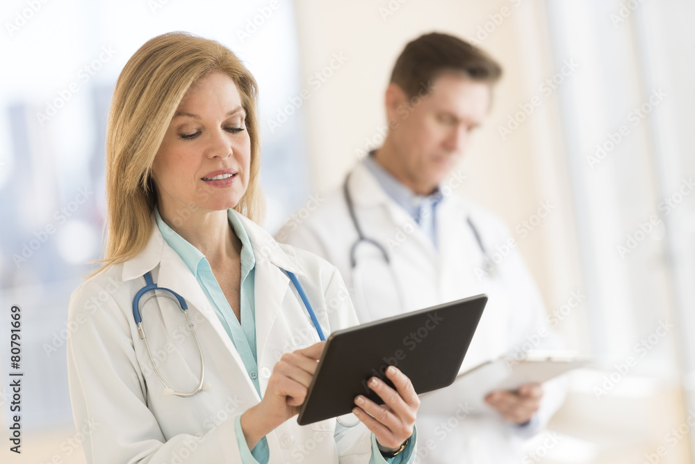 Female Doctor Using Digital Tablet At Hospital Female Doctor Using Digital Tablet At Hospital