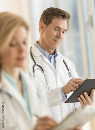 Male Doctor Using Digital Tablet At Hospital