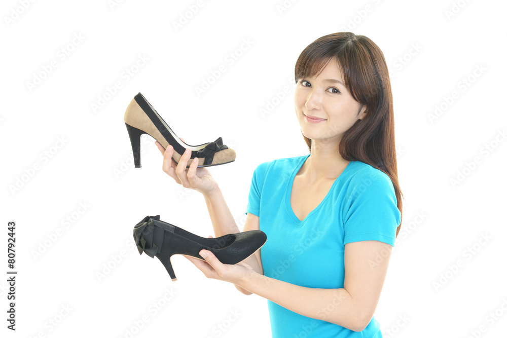 靴を持つ笑顔の女性 靴を持つ笑顔の女性