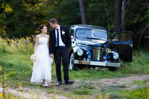A wedding couple with old car © castenoid