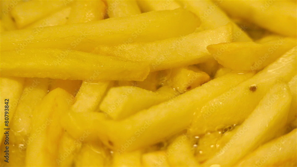 Gold brown french fries baking in a frying pan Gold brown french fries baking in a frying pan