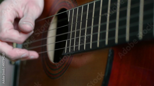 Close up of a man playing an acoustic guitar
