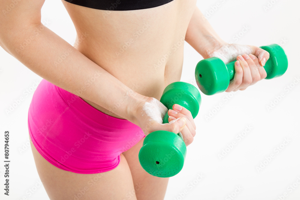 Fitness girl with green dumbbells Fitness girl with green dumbbells