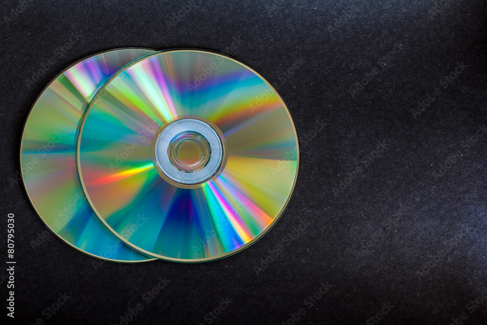 compact discs and digital versatile disc on a black background compact discs and digital versatile disc on a black background