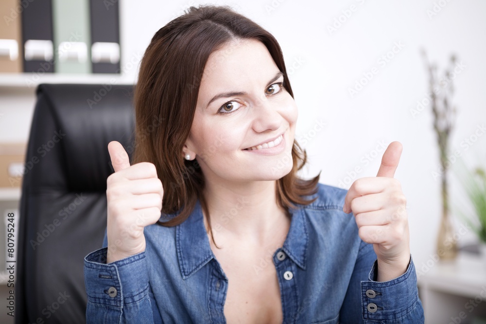 Happy triumphant businesswoman giving a thumbs up Happy triumphant businesswoman giving a thumbs up