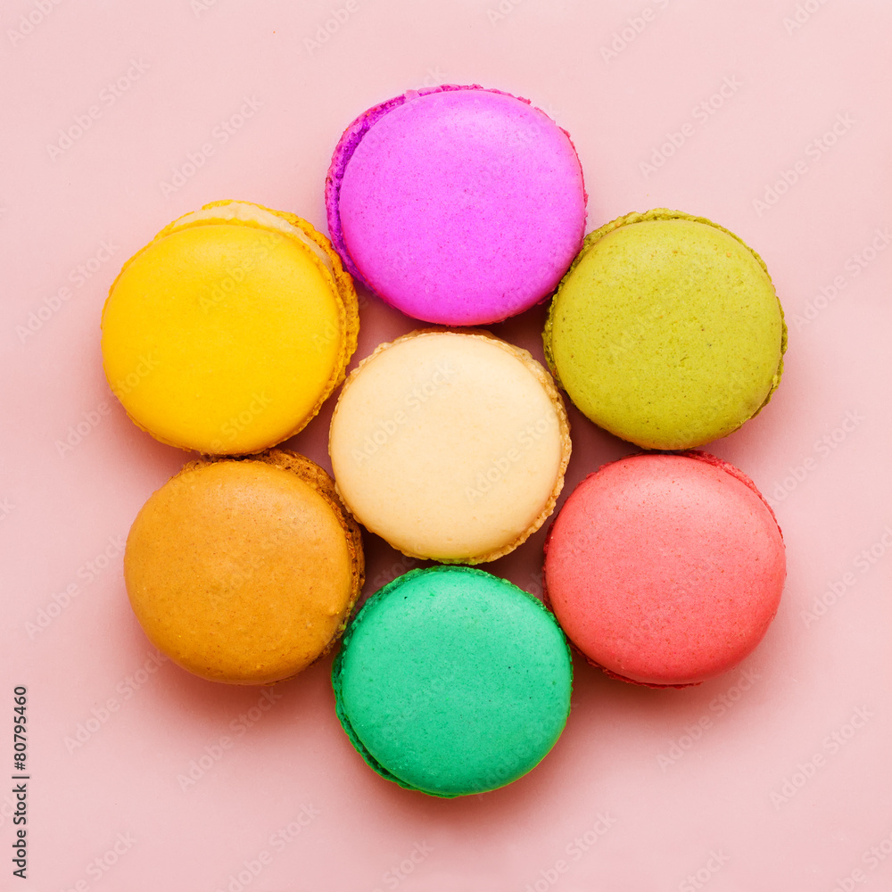 Sweet colorful macaroons against pink background. Top view Sweet colorful macaroons against pink background. Top view